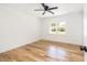 A bright bedroom featuring hardwood floors, a ceiling fan, and a view to the backyard at 1199 Island View Dr, Mount Pleasant, SC 29464