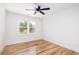 A bright bedroom featuring hardwood floors, a ceiling fan, and a view to the backyard at 1199 Island View Dr, Mount Pleasant, SC 29464
