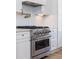 Modern kitchen features a stainless steel range, white cabinets, and a pot filler faucet at 1199 Island View Dr, Mount Pleasant, SC 29464
