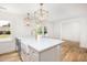 Stylish kitchen features a white farmhouse sink, pendant lights, and an island at 1199 Island View Dr, Mount Pleasant, SC 29464
