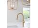 Bright kitchen with gold faucet and white quartz countertops under pendant lighting at 1199 Island View Dr, Mount Pleasant, SC 29464