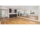 Open floor plan living area with hardwood floors, kitchen with bar, and dining area at 1199 Island View Dr, Mount Pleasant, SC 29464