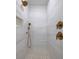 Luxury bathroom shower with gold fixtures, marble tiles, and a patterned tile floor at 1199 Island View Dr, Mount Pleasant, SC 29464