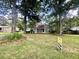 Charming single-story home with mature trees and a lush green lawn and a 'for sale' sign in the yard at 120 Wanda Dr, Summerville, SC 29485