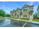 Tan townhomes exhibit tidy landscaping, symmetrical design, and bright entryways at 1202 Twin Rivers Dr, Wando, SC 29492