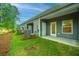 Exterior view of townhomes with green lawn and a covered patio space at 1202 Twin Rivers Dr, Wando, SC 29492