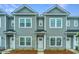 Well-maintained gray townhomes show classic design and appealing landscaping at 1202 Twin Rivers Dr, Wando, SC 29492