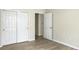 Bedroom with sliding closet doors, wood floors, and open door to hallway at 1225 Blakeway St # 703, Charleston, SC 29492
