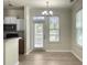 Bright dining area with a modern chandelier and adjacent kitchen with eat in area at 1225 Blakeway St # 703, Charleston, SC 29492