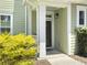 Entrance of a home with light green siding and a well-maintained front yard at 1225 Blakeway St # 703, Charleston, SC 29492
