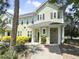 Exterior view of the two-story home featuring light green siding and a covered porch with a walkway at 1225 Blakeway St # 703, Charleston, SC 29492