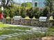 Stone grill with stone base and walkway surrounded by manicured bushes and grass at 1225 Blakeway St # 703, Charleston, SC 29492