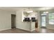 Cozy kitchen featuring white cabinets and black appliances with eat in dining area at 1225 Blakeway St # 703, Charleston, SC 29492