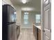 Galley kitchen with stainless steel appliances and wood-style flooring open to the dining area at 1225 Blakeway St # 703, Charleston, SC 29492