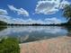 Beautiful lake view with a brick path and clear blue skies and clouds in the background at 1225 Blakeway St # 703, Charleston, SC 29492