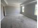 Large unfinished bedroom with trim detail, grey walls and two windows at 127 Seaton St, Summerville, SC 29486
