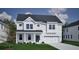 Charming two-story home with white siding, a gray roof, manicured landscaping, and an attached two-car garage at 127 Seaton St, Summerville, SC 29486