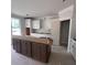 Unfinished kitchen area showcasing white upper cabinets, dark wood base cabinets, and natural light at 127 Seaton St, Summerville, SC 29486