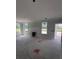Bright living room showing large windows, a door to the outside, and a fireplace awaiting completion at 127 Seaton St, Summerville, SC 29486
