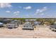 Aerial view of homes on sandy beach with green trees and a cloudy blue sky at 128 Palmetto Blvd, Edisto Beach, SC 29438