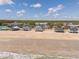 Panoramic view of the beachfront homes on a wide sandy beach with ocean waves at 128 Palmetto Blvd, Edisto Beach, SC 29438