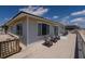 Charming beach house deck with Adirondack chairs and views of the ocean under a blue sky at 128 Palmetto Blvd, Edisto Beach, SC 29438