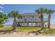 Charming raised beach house with palm trees and ocean views at 128 Palmetto Blvd, Edisto Beach, SC 29438