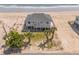 Exterior aerial view of a beach house with palm trees and ocean breezes at 128 Palmetto Blvd, Edisto Beach, SC 29438