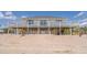 Beach house elevated with dune fencing and wide porch at 128 Palmetto Blvd, Edisto Beach, SC 29438