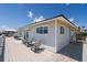 Exterior showing deck with multiple seating areas and the home's light gray siding at 128 Palmetto Blvd, Edisto Beach, SC 29438