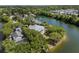 Aerial shot featuring a beautifully landscaped home on the water with a light roof and many trees at 1391 Royston Rd, Mount Pleasant, SC 29464