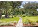 Tranquil backyard with a stone walkway, picnic table, and waterfront view at 1391 Royston Rd, Mount Pleasant, SC 29464