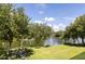 Lush backyard with a view of the lake, beautiful landscaping, and a relaxing firepit area at 1391 Royston Rd, Mount Pleasant, SC 29464