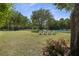 Backyard with lush grass, lake view, and set of four Adirondack chairs at 1391 Royston Rd, Mount Pleasant, SC 29464
