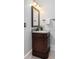 Elegant bathroom vanity featuring dark wood cabinetry, granite countertop, and modern fixtures in a well-lit space at 1391 Royston Rd, Mount Pleasant, SC 29464