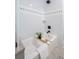 Modern bathroom showcasing white tiled walls, a sleek bathtub, and contemporary black fixtures for a clean aesthetic at 1391 Royston Rd, Mount Pleasant, SC 29464