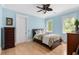 Bedroom features hardwood floors, light blue walls, and bright natural light from two windows at 1391 Royston Rd, Mount Pleasant, SC 29464