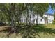 Exterior of white two-story home with green yard, surrounded by trees at 1391 Royston Rd, Mount Pleasant, SC 29464