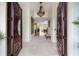 Grand foyer with tile floors, elegant lighting, and custom wood double doors at 1391 Royston Rd, Mount Pleasant, SC 29464