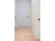 Hallway featuring hardwood floors and multiple doors with white trim and black hardware at 1391 Royston Rd, Mount Pleasant, SC 29464