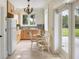 Cozy kitchen area featuring light wood cabinetry, a tiled backsplash, and an adjacent dining space near large windows at 1391 Royston Rd, Mount Pleasant, SC 29464