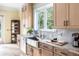 Well-lit kitchen sink area with stone countertops and stainless fixtures at 1391 Royston Rd, Mount Pleasant, SC 29464
