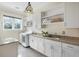 Bright laundry room with modern appliances, ample cabinet space, and a granite countertop sink at 1391 Royston Rd, Mount Pleasant, SC 29464