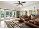 Open-concept living room with large windows and view of the balcony and surrounding nature at 1391 Royston Rd, Mount Pleasant, SC 29464
