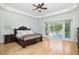 Spacious main bedroom featuring a king-size bed and a private balcony overlooking lush greenery at 1391 Royston Rd, Mount Pleasant, SC 29464