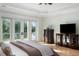 Main bedroom featuring hardwood floors, tray ceiling, and private balcony with a water view at 1391 Royston Rd, Mount Pleasant, SC 29464