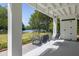 Covered porch with a swing offering scenic views of lake and lush lawn at 1391 Royston Rd, Mount Pleasant, SC 29464