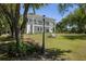 Charming two-story home with a spacious lawn, inviting porch swings, and well-maintained landscaping at 1391 Royston Rd, Mount Pleasant, SC 29464