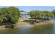 Beautiful lakeside property with lush lawn, mature trees, and a charming view of the water at 1391 Royston Rd, Mount Pleasant, SC 29464