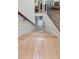 Elegant staircase with hardwood steps, decorative iron railings, and natural light from the open entryway at 1391 Royston Rd, Mount Pleasant, SC 29464